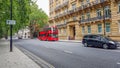 London, UK - July 8, 2020: Modern red double-decker bus passing by Hyde Park Place building in central London Royalty Free Stock Photo
