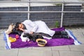 London, UK, July, 2019. Poor homeless man or refugee sleeping on the urban street in the city, social documentary concept,