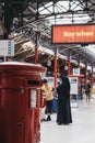 Post box inside Marylebone Station in London, UK, people behind