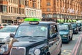 LONDON, UK - JULY 3RD, 2015: City traffic along a congested road. Row of black cabs Royalty Free Stock Photo