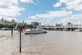 London / UK, July 15th 2019 - A boat on the river Thames with a view of Whitehall Court and Hungerford and Golden Jubilee bridge