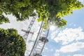 London / UK, July 15th 2019 - The London Eye through leafy trees against a beautiful blue sky Royalty Free Stock Photo