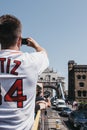 Tourist taking a photo of Tower Bridge, London, UK, on mobile phone from a tour bus, selective focus Royalty Free Stock Photo