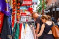 Tourists browsing outside a clothing and souvenir shop in Chinat Royalty Free Stock Photo