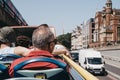 Tourists enjoying city views from top deck of of tour bus in London, UK Royalty Free Stock Photo