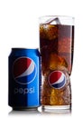 LONDON, UK - JUNE 9, 2017: Aluminium can and glass with ice cubes of Pepsi Cola soft drink on white.American multinational food an