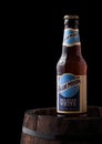 LONDON, UK - JUNE 06, 2018: Bottle of Blue Moon belgian white beer, brewed by MillerCoors on old wooden barrel.