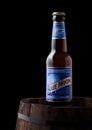 LONDON, UK - JUNE 06, 2018: Bottle of Blue Moon belgian white beer, brewed by MillerCoors on old wooden barrel.