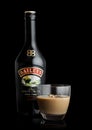 LONDON, UK - JUNE 02, 2020: Bottle and glass of Baileys Original Irish Cream on black. Irish whiskey and cream based liqueur