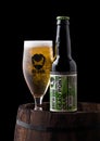 LONDON, UK - JUNE 06, 2018: Bottle and glass of Dead Pony Club pale ale beer, from the Brewdog brewery on old wooden barrel Royalty Free Stock Photo