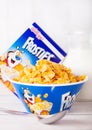 LONDON, UK - JUNE 01, 2018: Box of Kellogg`s Frosties Breakfast Cereal with milk and plate on white wood. Royalty Free Stock Photo