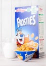 LONDON, UK - JUNE 01, 2018: Box of Kellogg`s Frosties Breakfast Cereal with milk and plate on white wood. Royalty Free Stock Photo