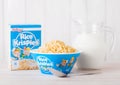 LONDON, UK - JUNE 01, 2018: Box of Kellogg`s Rice Krispies Breakfast Cereal with original plate and milk on white wood. Royalty Free Stock Photo