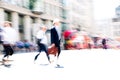 Business people and office workers crossing the road. Walking people motion blur. City of London busy business life.