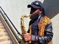 London, UK - June 21 2018 - A busker plays the saxaphone in London, at the Paddington Green underpass