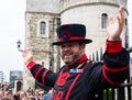 Cheerful Yeoman Warder leads visitors on a tour at the Tower of London Royalty Free Stock Photo