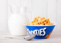 LONDON, UK - JUNE 01, 2018: original plate of Kellogg`s Frosties Breakfast Cereal with milk on white wood. Royalty Free Stock Photo