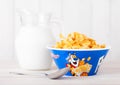 LONDON, UK - JUNE 01, 2018: original plate of Kellogg`s Frosties Breakfast Cereal with milk on white wood. Royalty Free Stock Photo