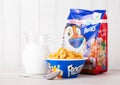 LONDON, UK - JUNE 01, 2018: Pack of Kellogg`s Frosties Breakfast Cereal with milk and plate on white wood. Royalty Free Stock Photo