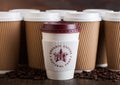 LONDON, UK - JUNE 05, 2019: Pret A Manger Coffee Paper Cup for take away with coffee beans on wooden background with blank brown Royalty Free Stock Photo