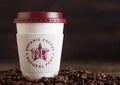 LONDON, UK - JUNE 05, 2019: Pret A Manger Coffee Paper Cup for take away with coffee beans on wooden background Royalty Free Stock Photo