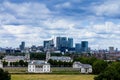 Skyline view of the skyscrapers of Canary Wharf and national maritime museum, shot from Greenwich park - London, UK Royalty Free Stock Photo