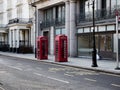 Two red telephone boxes on a street in central London Royalty Free Stock Photo