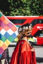 Man wearing a red cape and feather hat at Extinction Rebellion Protest at Parliament square