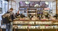 Customer at counter paying for food at Itsu Health and Happiness restaurant in London, UK. The restaurant chain inspired