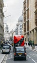 Heritage red Routemaster Bus operating in the City of London. Open platform at back facilitated speedy boarding under Royalty Free Stock Photo