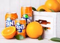 LONDON, UK - MARCH 31, 2018: Aluminium tins of Fanta orange soft drink on white wooden background Royalty Free Stock Photo