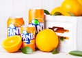 LONDON, UK - MARCH 31, 2018: Aluminium tins of Fanta orange soft drink on white wooden background Royalty Free Stock Photo