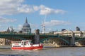 Boat travels under Southwark Bridge on the