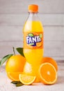 LONDON, UK - MARCH 31, 2018: Plastic bottle of Fanta orange soft drink on light wooden background with fresh oranges Royalty Free Stock Photo