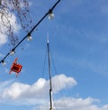 Red chair hanging from an electricty cable on the Embankment in London on March 11, 2019