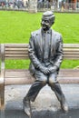 Statue of Mr Bean sitting on a bench. Rowan Atkinson bronze statue in London. UK Royalty Free Stock Photo