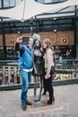 Tourists taking photos with Amy Winehouse statue in Camden, London, UK