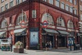 Two women walking outside closed Covent Garden station in London, UK, motion blur Royalty Free Stock Photo