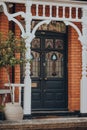 Black stained glass front door of a traditional Edwardian house in London, UK, selective focus Royalty Free Stock Photo