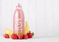 LONDON, UK - MAY 03, 2018: Bottle of Innocent strawberry and banana smoothie fruit drink with vitamins on wooden background.