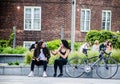 Two ladies sitting and talking outside with a bicycle next to them