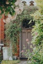 Plants and arch outside front door of a house in Palmers Green, London, UK, selective focus