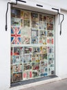 A restaurant shop window covered with newspaper pages for security and privacy.