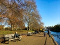 People relaxing on bench by the lake in morning at St James`s park in London