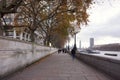 Riverside pedestrian walkway alongside River Thames London in afternoon