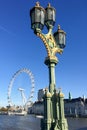 Metal lamp post on Westminster Bridge in sunny morning with London Eye and County Hall in background Royalty Free Stock Photo
