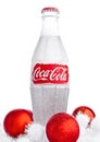 LONDON, UK - NOVEMBER 07, 2016: Classic bottle Of Coca-Cola on white background with christmas toys and snow