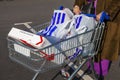 Shopping trolley cart full of plastic carrier bags