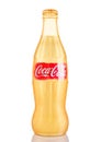 LONDON, UK - NOVEMBER 07, 2016: Golden classic bottle of Coca-cola with logo on white
