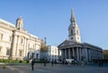 Pedestrians walk around historic St. Martin in the fields church